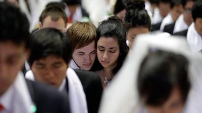 Couples from around the world pray in a mass wedding ceremony at the CheongShim Peace World Centre in Gapyeong, South Korea, on Sunday. Lee Jin-man / AP Photo