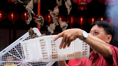 A man releases birds in Jakarta. Beawiharta / Reuters