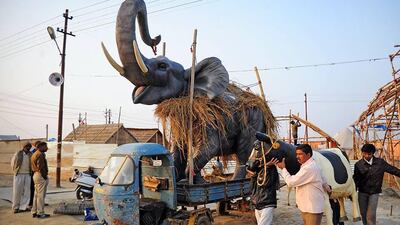 Indian labourers remove animal statues from a tent used during the annual Magh Mela festival at Sangam in Allahabad. Sanjay Kanokia / AFP