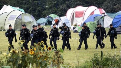 French gendarmes walk by tents during the evacuation of the Grande-Synthe migrant camp on Tuesday. AFP