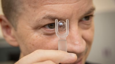 Valentyn Volkov, co-founder and scientific partner at Xpanceo, with a prototype smart contact lens. Antonie Robertson / The National
