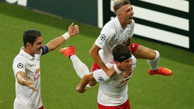 Franz Schiemer, right, Jonatan Soriano, left and Kevin Kampl, top, celebrate their first goal in Red Bull Salzburg's 2-1 first-leg win over Malmo. Krgufoto / EPA