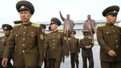 North Korean soldiers marking the 85th anniversary of the founding of the Korean People’s Army walk in front of the bronze statues of Kim Il-sung and Kim Jong-il in Pyongyang. Kyodo / via Reuters