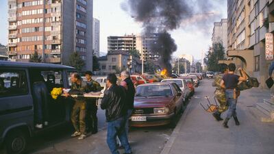 A casualty is helped into a van after a bombing in Sarajevo, circa 1992. Getty Images
