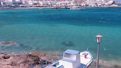 A boat on land by the sea overlooking the old port in Mykonos, Greece. Loulou D'Aki/Bloomberg