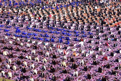 School students gather to practise yoga on at Ranital stadium as India celebrated Swami Vivekananda's birth anniversary. AFP