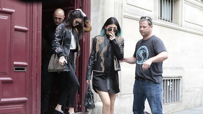 Kendall Jenner, centre, and Kylie Jenner, leave Kanye West’s Paris apartment on May 20, 2014. . Jacques Brinon / AP photo