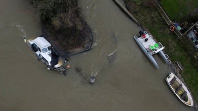 A boat is half-submerged in the flooded Thames in Oxford. AP