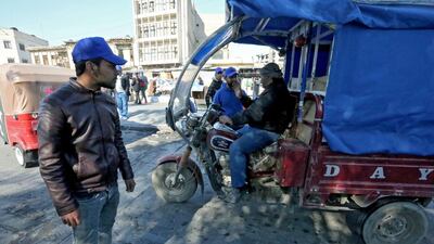 Supporters of Iraqi's firebrand cleric Moqtada Al Sadr, recognisable by their signature blue caps, man a makeshift checkpoint in Baghdad's Tahrir Square to search vehicles on February 4, 2020. AFP