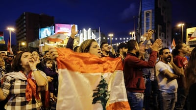 Lebanese anti-government demonstrators wave flags and shout slogans during a demonstration in Tripoli's Al Nour Square. AFP
