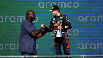 Race winner Max Verstappen on the podium with NBA legend Shaquille O'Neal. AFP