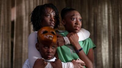 Evan Alex, Lupita Nyong'o and Shahadi Wright Joseph in a scene from "Us," written, produced and directed by Jordan Peele. (Claudette Barius/Universal Pictures via AP)