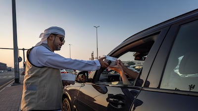 Emirates Red Crescent and police are handing out iftar boxes to motorists in Dubai before sunset. Antonie Robertson/The National