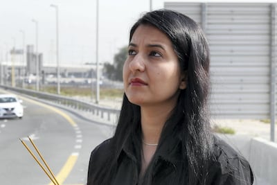 Sapna Moolchandani lights incense sticks in memory of her sister Roshni, among 17 passengers who were killed nearly two years ago in a bus accident near the Al Rashidiya exit in Dubai. Pawan Singh / The National