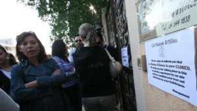 Regular customers of La Maison d'Hotes gather at the front gate after it was closed for business. Readers lament the passing of the elegant boutique hotel.