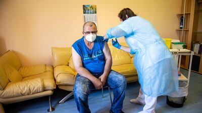 A man is vaccinated against Covid-19 in Slovakia, but an imbalance of available doses is up for discussion among world leaders. AFP