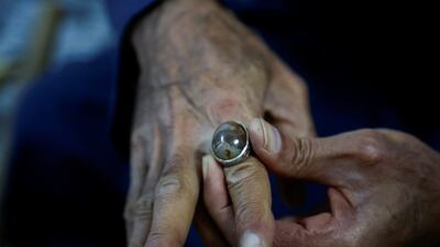 Mr Suaan displays a gemstone which he has mounted on a ring