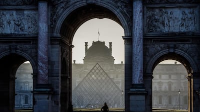 A woman runs under the Arc de Triomphe du Carrousel by the Louvre museum pyramid in Paris, France. Paris, at no.6, is expected to benefit from any shift of European visitors from the United Kingdom for both business and leisure. AFP
