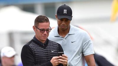 Tiger Woods, right, with swing coach Sean Foley, with whom he parted ways this week. Paul Ellis / AFP