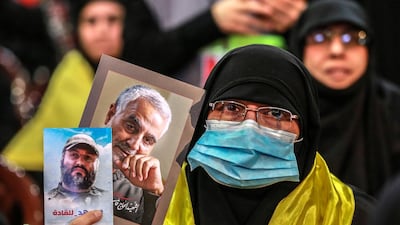 A Hezbollah supporter holds a photo of Qassem Suleimani during a rally to mark the group's Martyrs Day. EPA