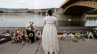 A woman mourns the victims on the first anniversary of the Mermaid boat accident near Margaret bridge, at the Danube River, in Budapest, Hungary. Reuters