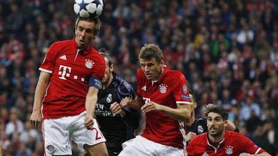 Bayern Munich captain Philipp Lahm, left, heads the ball ahead of Gareth Bale. Michaela Rehle / Reuters