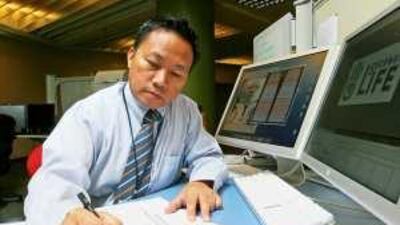 Renato Quero, a multimedia developer at the Dubai Women's College, sketches a design for a virtual abaya that will be sold by students on the school's Second Life campus as part of their e-commerce programme.