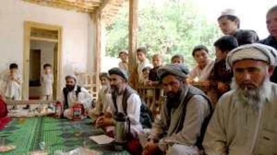 Borhan Koja, centre, holds a meeting of one of 120 shuras in Samangan province.