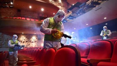 Workers fumigate a theatre in Seoul on June 16. South Korean authorities say the Mers outbreak is over. Jung Yeon-je / AFP Photo