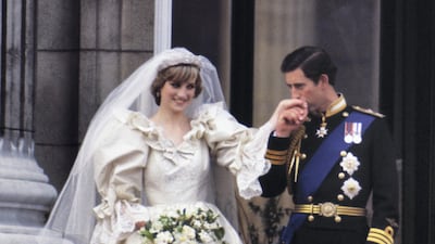 Princess Diana on the balcony of Buckingham Palace on her wedding day in 1981. The wedding dress is to go on public display for the first time in more than 25 years. Getty Images