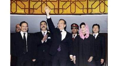 The Chinese prime minister, Wen Jiabao, waves as his Pakistani counterpart, Yusuf Raza Gilani, second from left, applauds after Wen's arrival at the joint sessions of the National Assembly and Senate yesterday in Islamabad. Reuters