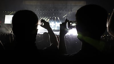 People recording the performance of DJ Martin Garrix during the F1 concert held at Etihad Park in Abu Dhabi. Pawan Singh/The National