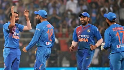 Indian players celebrate the dismissal of West Indies' Lendl Simmons during the third Twenty20 at the Wankhede Stadium in Mumbai. AP