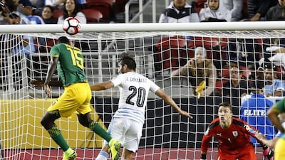 Jamaica’s Je-Vaughn Watson, left, tries to score on a header against Uruguay. Tony Avelar / AP Photo