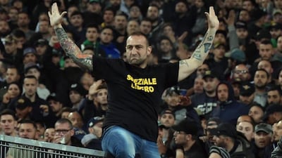 Gennaro de Tommaso, the leader of SSC Napoli 'Curva A' supporters, wears a shirt reading 'Speziale Libero' as he sits on the railing prior the Italy Cup final soccer match ACF Fiorentina vs SSC Napoli at Olimpico stadium in Rome, Italy, 03 May 2014. According to news reports on 04 May, the shirt apparently referred to a jailed Italian soccer fan who killed a police officer by throwing a block of concrete outside a soccer match in 2007. Ettore Ferrari / EPA