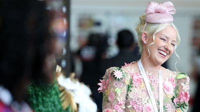 An attendee at the 2025 Dubai World Cup wears pastel florals, with a light pink fascinator. Chris Whiteoak / The National