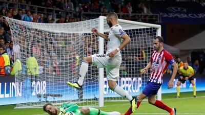 Atletico's goalkeeper Jan Oblak in action with Real's Karim Benzema. Reuters
