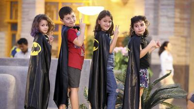 Children post wearing capes as they take part in helping set the Guinness World Record for Batman’s 80th anniversary held at Warner Bros in Abu Dhabi. Pawan Singh / The National