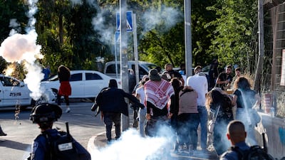 Israeli security forces fire tear gas at the entrance of the Sheikh Jarrah neighbourhood in occupied east Jerusalem, during a rally demanding the reopening of roadblocks on May 29. AFP