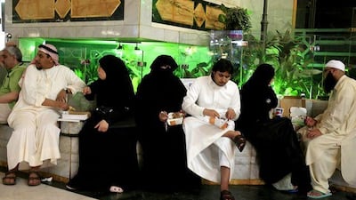 Saudi and foreign Muslims eat fast food in a shopping mall in Mecca, as the debate rages over segregation of the sexes.