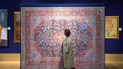 Auctioneer Ralph Taylor of Bonham's Auctioneers on New Bond Street, London, UK, sells works of art from the Abraaj collection, which include Manjit Bawa's oil on Canvas 'Untitled' and Rashid Rana's 'Red Carpet' (pictured). Picture by Ben Stevens / i-Images