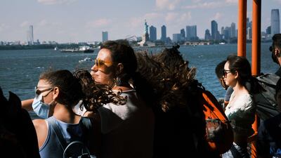 People ride on the Staten Island Ferry on July 30 in New York City. Due to the rapidly spreading Delta variant, New York City Mayor Bill de Blasio has announced that the city will require all city workers to be vaccinated or tested weekly for Covid-19 and the city will now pay people $100 to get the shot. Getty / AFP