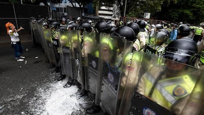 Demonstrators clash with police in an opposition march led by Miranda state Governor Henrique Capriles, as they are blocked from reaching the National Electoral Court in Caracas to demand validation of the signatures to initiate a recall referendum against President Nicolas Maduro. Juan Barreto / AFP