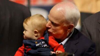 Republican presidential candidate Sen John McCain kisses a 9-month old child during a rally in Davenport, Iowa.