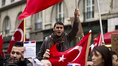 People rally outside the French National Assembly in Paris after parliament passed a bill which would see anyone who denied the 1915 Armenian genocide face up to a year and fined €45,000 (Dh215,300).