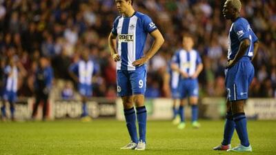 Wigan players are dejected after defeat to Swansea City. Laurence Griffiths / Getty Images