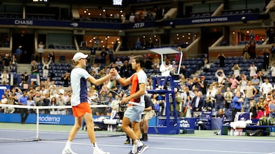 Carlos Alcaraz and Jannik Sinner shake hands at the end of their US Open quarterfinal. EPA
