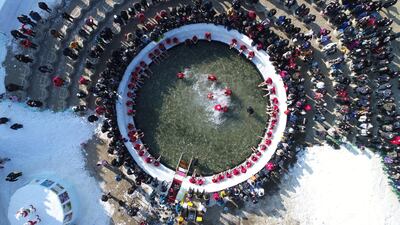 An image taken with a drone shows festival visitors fishing on a ice pool during the Hwacheon Sancheoneo Ice Festival at Hwacheon-gun in Gangwon province, South Korea. EPA
