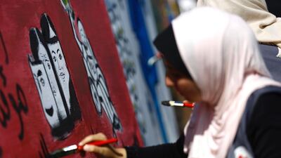 A Palestinian art student paints as she takes part in a festival marking the World Mental Health Day in Gaza City. Mohammed Abed / AFP
