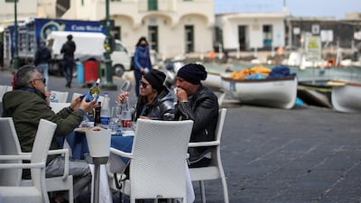 People sit at a restaurant on the Italian tourist island of Capri. Reuters